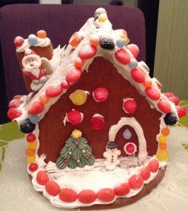 One Gingerbread House, all done and dusted. Literally and liberally dusted with icing sugar. That wasn't in the instructions, but we like to improvise. We're very proud of our little gingerbread house!